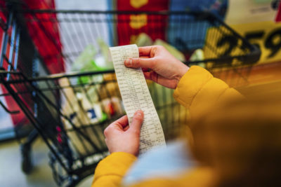 A person checking their bill in a grocery store